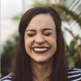 user profile picture of a woman with brown hair laughing and showing teeth